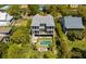 Aerial view of a beautiful two-story home with a pool, fire pit, and outdoor space surrounded by greenery at 409 W Indian Ave, Folly Beach, SC 29439