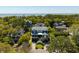 Stunning elevated view of a two-story home nestled in a lush, green neighborhood near the ocean at 409 W Indian Ave, Folly Beach, SC 29439