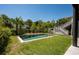 Backyard with a swimming pool, patio with seating, and lush landscaping at 409 W Indian Ave, Folly Beach, SC 29439