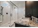 Modern bathroom featuring sleek glass shower and granite countertops at 409 W Indian Ave, Folly Beach, SC 29439