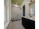 Modern bathroom features tiled floors, glass enclosed shower, and a black vanity at 409 W Indian Ave, Folly Beach, SC 29439