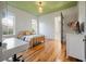 Bright bedroom with green ceiling, natural light, and minimalist decor at 409 W Indian Ave, Folly Beach, SC 29439