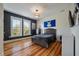 Well-lit bedroom with hardwood floors, featuring two windows and a neutral color scheme at 409 W Indian Ave, Folly Beach, SC 29439