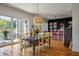 Dining room with modern lighting fixture and a view into the kitchen at 409 W Indian Ave, Folly Beach, SC 29439