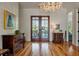 Bright foyer featuring hardwood floors, elegant decor, and double doors at 409 W Indian Ave, Folly Beach, SC 29439
