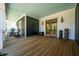 Expansive front porch boasting wood floors, comfortable seating, and stylish decor at 409 W Indian Ave, Folly Beach, SC 29439