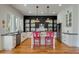 Modern kitchen with white cabinets, stainless steel appliances, a kitchen island, and hardwood floors at 409 W Indian Ave, Folly Beach, SC 29439