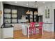 Modern kitchen with white cabinets, stainless steel appliances, a kitchen island, and hardwood floors at 409 W Indian Ave, Folly Beach, SC 29439