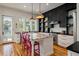 Well-designed kitchen featuring an island, stainless steel appliances, and open shelving with colorful dishware at 409 W Indian Ave, Folly Beach, SC 29439