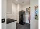 Functional laundry room with stacked washer/dryer and built-in cabinets at 409 W Indian Ave, Folly Beach, SC 29439