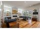 Elegant living room featuring hardwood floors, a fireplace, comfortable seating, and access to an outdoor area at 409 W Indian Ave, Folly Beach, SC 29439
