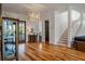 Open-concept living area featuring hardwood floors, staircase and elegant decor at 409 W Indian Ave, Folly Beach, SC 29439