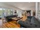 Comfortable living room with hardwood floors, fireplace, and access to the patio at 409 W Indian Ave, Folly Beach, SC 29439