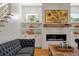 Cozy living room with fireplace, built-in shelves, and a comfortable gray sofa at 409 W Indian Ave, Folly Beach, SC 29439