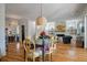 Open concept living and dining area with hardwood floors, a fireplace, and a large dining table at 409 W Indian Ave, Folly Beach, SC 29439