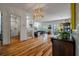 Open-concept living space with hardwood floors, modern lighting, and staircase at 409 W Indian Ave, Folly Beach, SC 29439