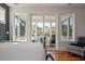 Bright main bedroom features a private balcony and plenty of natural light at 409 W Indian Ave, Folly Beach, SC 29439