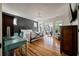 Large main bedroom with balcony access, hardwood floors, and dark accent wall at 409 W Indian Ave, Folly Beach, SC 29439