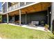 Covered outdoor space featuring a dining area and lounge seating, ideal for entertaining and enjoying the fresh air at 409 W Indian Ave, Folly Beach, SC 29439