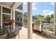 Outdoor porch area featuring stainless steel grill, seating area, and wood decking overlooking the landscaped yard at 409 W Indian Ave, Folly Beach, SC 29439