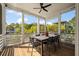 Inviting screened porch with a large dining table and chairs overlooking the lush, green backyard at 409 W Indian Ave, Folly Beach, SC 29439