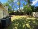 Spacious backyard featuring lush green grass, mature trees, and a wood fence at 411 Navaho Cir, Summerville, SC 29483