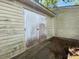Outside side view of weathered shed with aged siding and a pair of closed doors at 411 Navaho Cir, Summerville, SC 29483