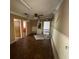 A spacious living room features hardwood floors, neutral walls, and a ceiling fan, though some renovation is needed at 411 Navaho Cir, Summerville, SC 29483