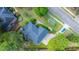 An aerial view of a home showing the landscaping, roof and nearby street at 4407 Wild Thicket Ln, North Charleston, SC 29420