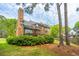 Exterior shot of home with brick, large chimney and green landscaping at 4407 Wild Thicket Ln, North Charleston, SC 29420