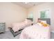 Cozy bedroom featuring two twin beds with pink bedding and a dresser at 4407 Wild Thicket Ln, North Charleston, SC 29420