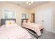 Bright bedroom with twin beds, soft carpet, and natural light at 4407 Wild Thicket Ln, North Charleston, SC 29420
