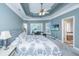 Spacious bedroom with large bed, tray ceilings, and a view into the en-suite bathroom at 4407 Wild Thicket Ln, North Charleston, SC 29420