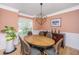 Dining room with stylish light fixture, table with chairs, and unique plant stand at 4407 Wild Thicket Ln, North Charleston, SC 29420