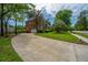 View of a spacious driveway leading to a two-story brick home with attached garage at 4407 Wild Thicket Ln, North Charleston, SC 29420
