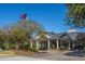 An inviting property entrance, flag, and well-maintained landscaping leading to the building at 4407 Wild Thicket Ln, North Charleston, SC 29420