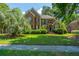 Charming two-story brick home with manicured front yard and mature landscaping at 4407 Wild Thicket Ln, North Charleston, SC 29420