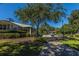 A building exterior with a sidewalk, shrubbery, trees, and a golf cart on a sunny day at 4407 Wild Thicket Ln, North Charleston, SC 29420