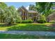 Charming two-story brick home featuring a well-kept lawn and manicured shrubbery at 4407 Wild Thicket Ln, North Charleston, SC 29420