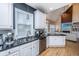 Modern kitchen with stainless appliances, white cabinetry, granite countertops, and hardwood floors at 4407 Wild Thicket Ln, North Charleston, SC 29420