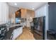 Open-concept kitchen and living area with stainless steel appliances and hardwood floors at 4407 Wild Thicket Ln, North Charleston, SC 29420