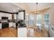 Eat-in kitchen area with white cabinets, stainless appliances, wood floors, and a breakfast table by a window at 4407 Wild Thicket Ln, North Charleston, SC 29420