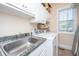 Well-lit laundry room featuring white cabinets, granite countertops, and a front-load washer and dryer at 4407 Wild Thicket Ln, North Charleston, SC 29420