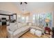 Bright living room with hardwood floors, a large sectional sofa, and natural lighting at 4407 Wild Thicket Ln, North Charleston, SC 29420