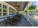 Inviting covered porch featuring outdoor seating, ceiling fans, and views of the surrounding landscape at 4407 Wild Thicket Ln, North Charleston, SC 29420