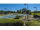 Several community tennis courts, with benches for resting, and lush, green landscaping at 4407 Wild Thicket Ln, North Charleston, SC 29420