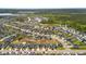 Expansive aerial view of a suburban community featuring well-maintained homes, green spaces, and a serene pond at 476 Foxbank Plantation Blvd, Moncks Corner, SC 29461