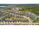 Expansive aerial view of a suburban community featuring well-maintained homes, green spaces, and a serene pond at 476 Foxbank Plantation Blvd, Moncks Corner, SC 29461