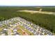 Aerial view showcasing a neighborhood's layout near lush woods, with rows of houses featuring well-kept yards and landscaping at 476 Foxbank Plantation Blvd, Moncks Corner, SC 29461