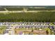 Overhead view of a suburban neighborhood adjacent to a forest, featuring orderly rows of houses and tree-lined streets at 476 Foxbank Plantation Blvd, Moncks Corner, SC 29461